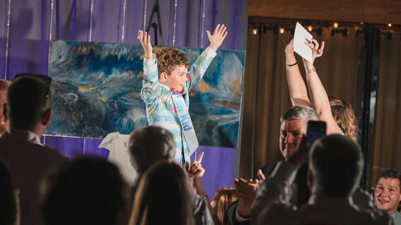 Wish kid Harrison celebration on stage at Wish Ball 2023