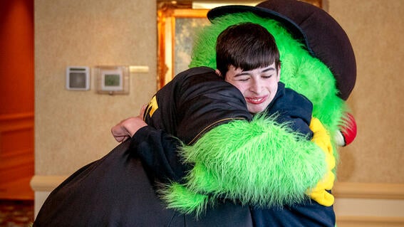 Gabe hugs the Pirate Parrot.