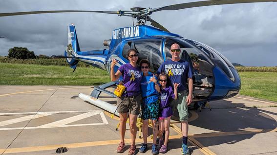 Rhydian, his parents Regina-Celeste and Bradley, and sister Noora, with the Blue Hawaiian Helicopter, getting ready for their waterfall adventure tour.