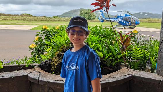 Rhydian in front of the Blue Hawaiian Helicopter before his wish to go see waterfalls in Hawaii.