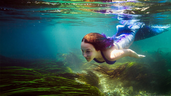 Emily swims in the water with her amazing new mermaid tail.