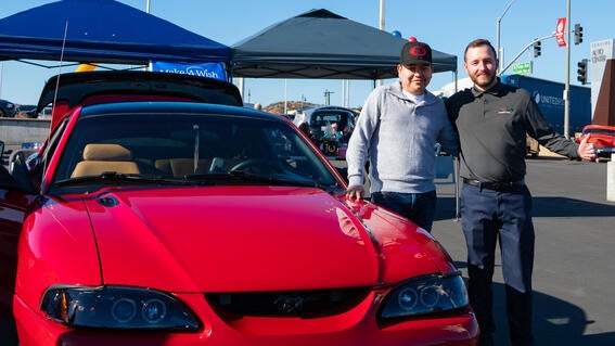 Ignacio with Christian Saban next to the restored Mustang.