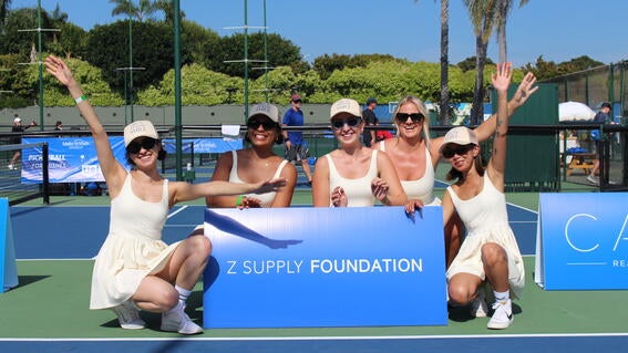 Pickleball for wishes 2023 players with sign