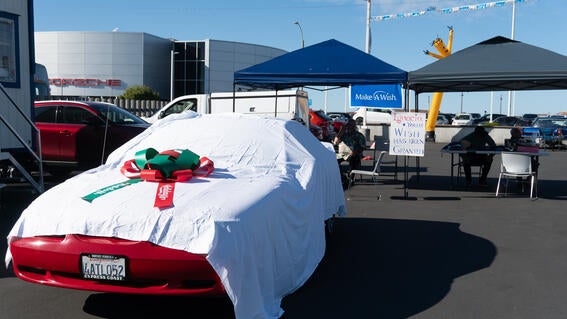 Ignacio's Mustang under a tarp and big red and green bow