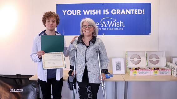 Nate poses with MassArt President Dr. Mary K. Grant at his wish celebration
