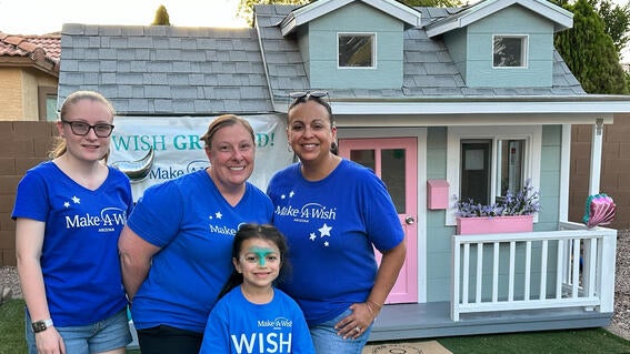 Abbie Tremp standing in front of playhouse for wish kid Quinn