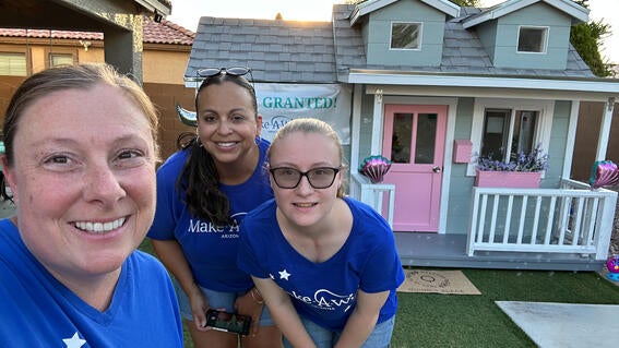 Abbie Tremp standing in front of playhouse for wish kid Quinn