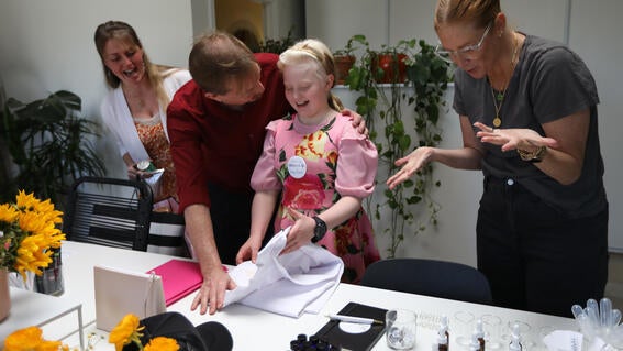 Monika with her father and owner Rosie as she receives her gifted customized lab coat