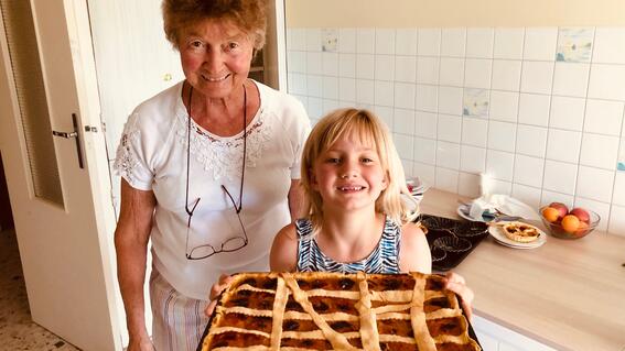 Monika baking a pie with her French grandmother right after her diagnosis of a brain tumor in 2020.