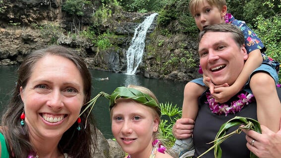 Nora and her family visiting a waterfall in Hawaii