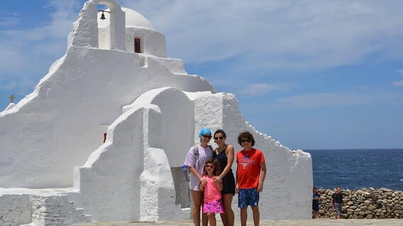 Elizabeth and family in front of white house in greece