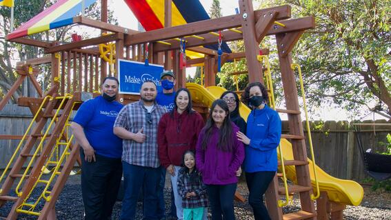 John Villanueva with staff, volunteers, wish kid Gabriella and her family during her wish celebration to have a backyard playset