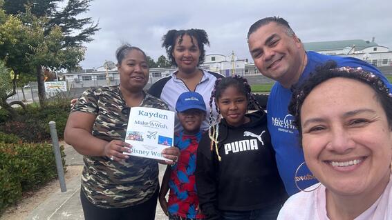 John Villanueva with staff, volunteers, wish kid Kayden during his wish reveal to go to Disney World