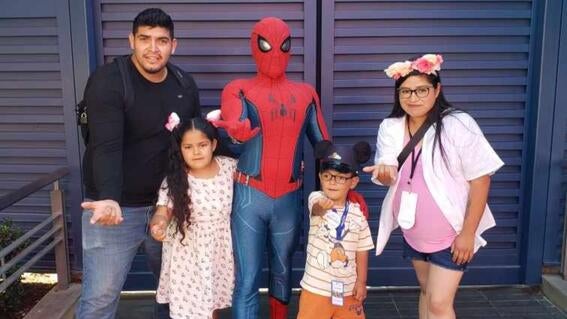 Leonel with his mom, Selene, dad, Alexis, and sister, Miranda with Spider-Man on his wish to go to Disneyland.