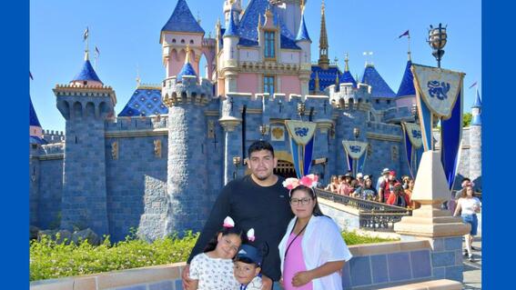 Leonel with his mom Selene, dad Alexis, and sister Miranda, at Disneyland in front of a castle