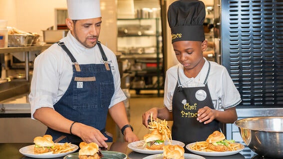 Prince and Chef Canales plating crab cake sandwiches