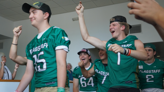 Stephen's teammates cheer him on as he enters the auditorium.