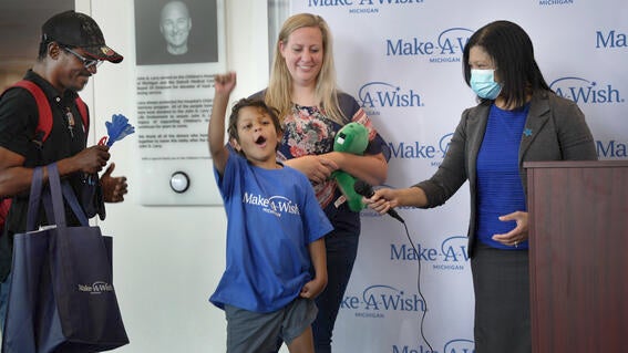 James cheering with excitement that he is the 12,000th wish