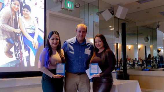 Senior Volunteer Manager Daniel Marlay presents Rosa Cortes (left) and Blanca Cortes (right) with the Wish It Forward Full Circle Award.