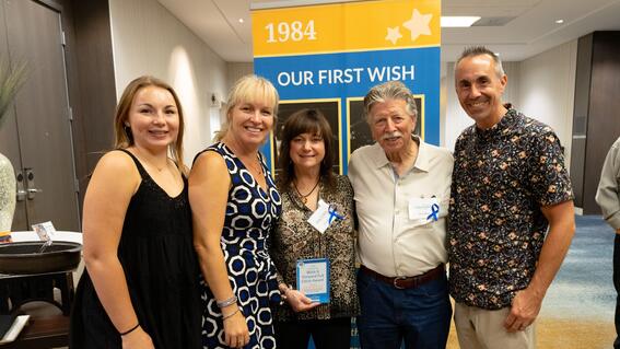 From left to right: McKenzie Dyer, Heather Dumas-Dyer, Larry and Lisa Olivo and Garrison Dyer accepting the Monterey Bay Wish It Forward Full Circle Award for Kissed by an Angel Wines.
