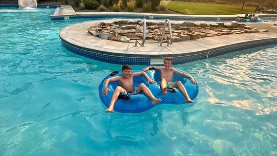 Kids on a raft in the middle of the water