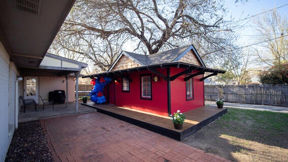 Red train house in backyard