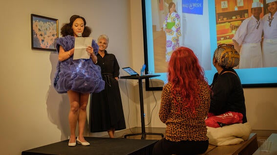 Katina standing on a stage with tulle fabric covered dress