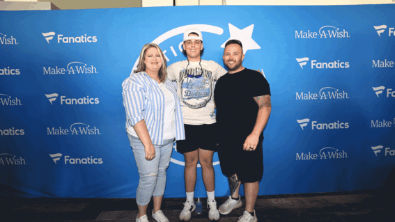 Braxton and parents standing in front of blue wall