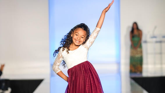 Mia wish kid with epilepsy on the runway at It's In The Bag