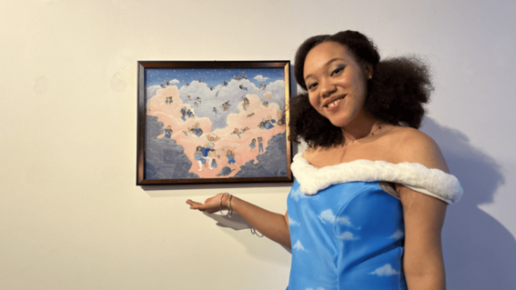 Katina standing next to her artwork