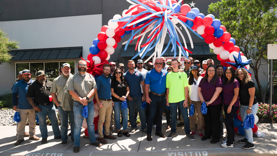 Group of people standing and smiling with wish kid Blane