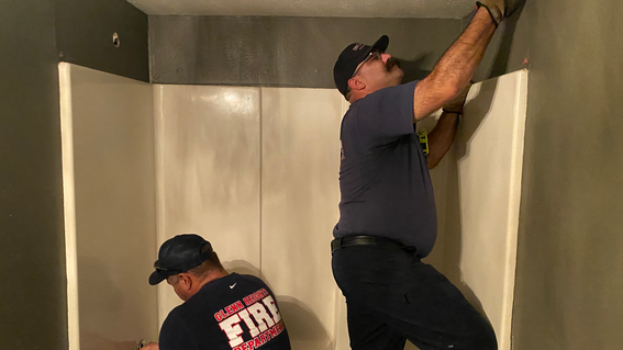 Firemen working on accessible shower