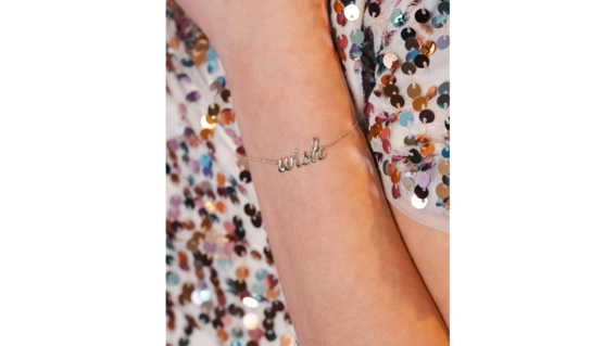 Wish child with "Wish" bracelet on her wrist