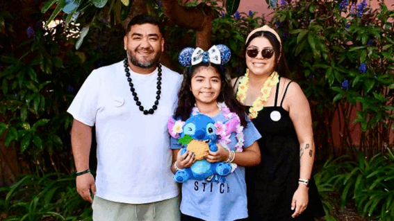 Sophia with her mom, dad, and Stitch