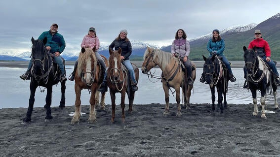 Lucy mounted a large draft horse named Tucker and set out into the rugged Alaskan wilderness.