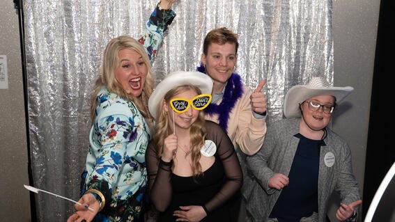 People in a photobooth with props