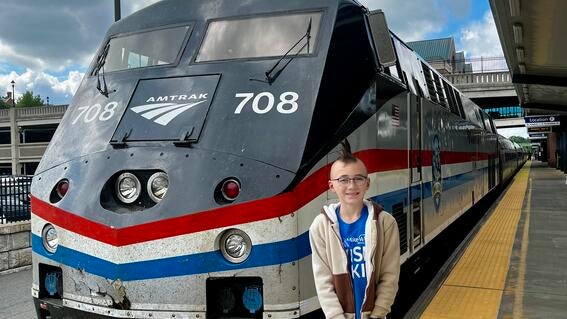 Brock standing in front of the train