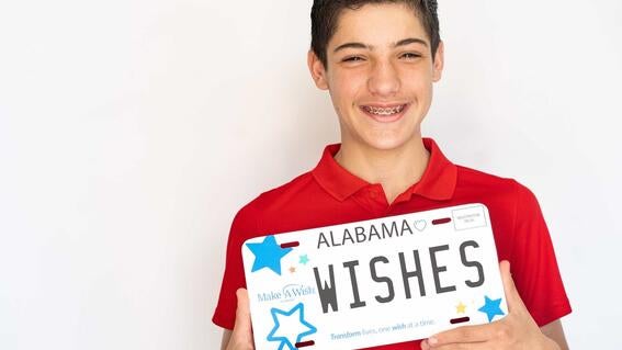 wish kid with Make-A-Wish Alabama car tag