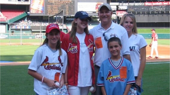 Group photo Sarah Betchel and her family on the baseball field in 2005