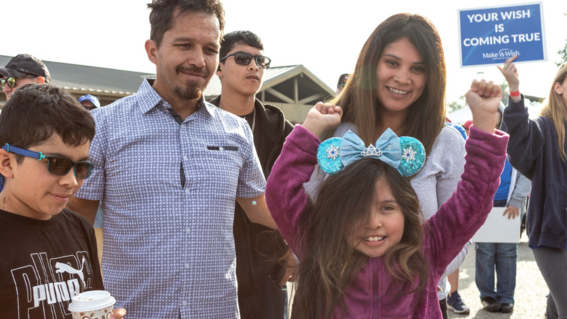 Wish kid Bridget with her family during her wish reveal.