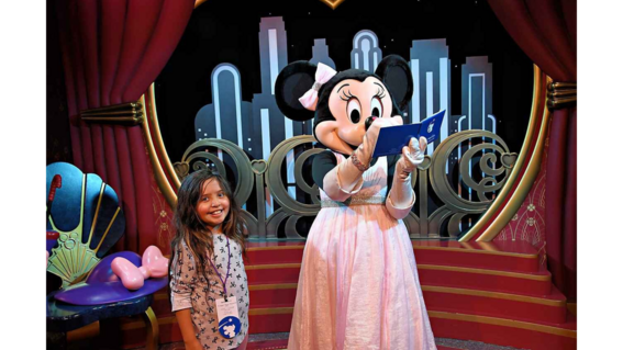 Bridget gets an autograph from Minnie Mouse.