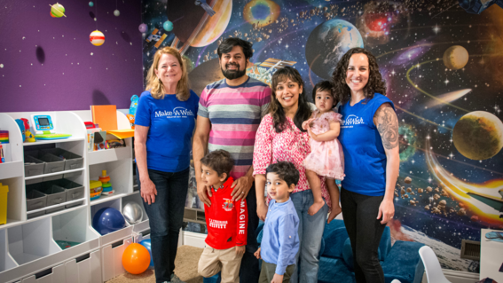 Jan with wish kid Raiyan and his family in his space-themed room.
