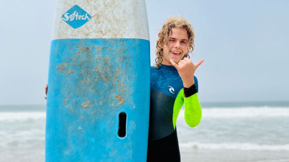 TJ wished to learn how to surf at the beach.