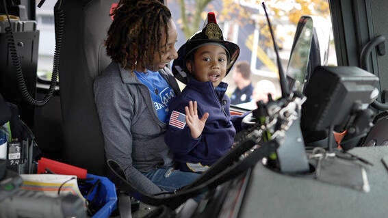 Jayce in the firetruck on his mom in the driver's seat