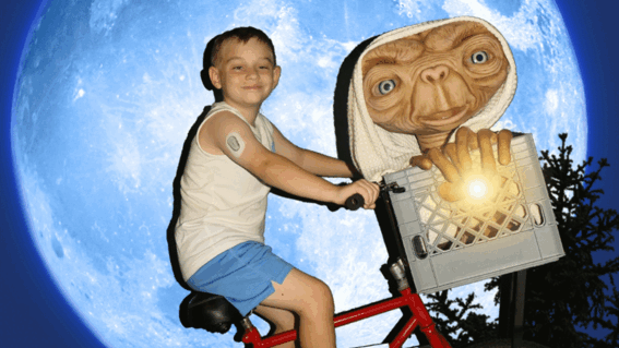 Leon riding bicycle with ET