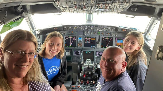 Briana and family in the cockpit of an airplane