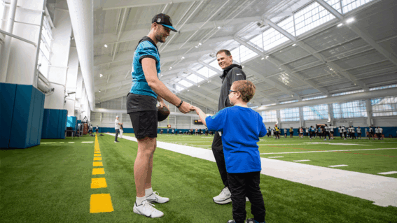 Blaze fist bumping a Jaguars' player