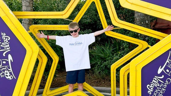 Noah poses at Give Kids the World Village