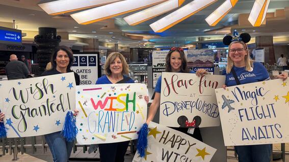 Kristen McElliott stands with volunteers at Wish Flight.