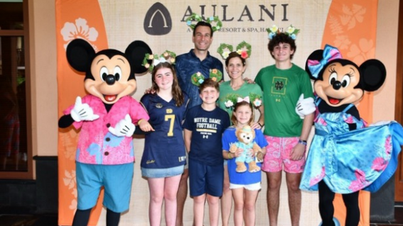 Grace and her family at Disney's Aulani Resort with Miney and Mickey